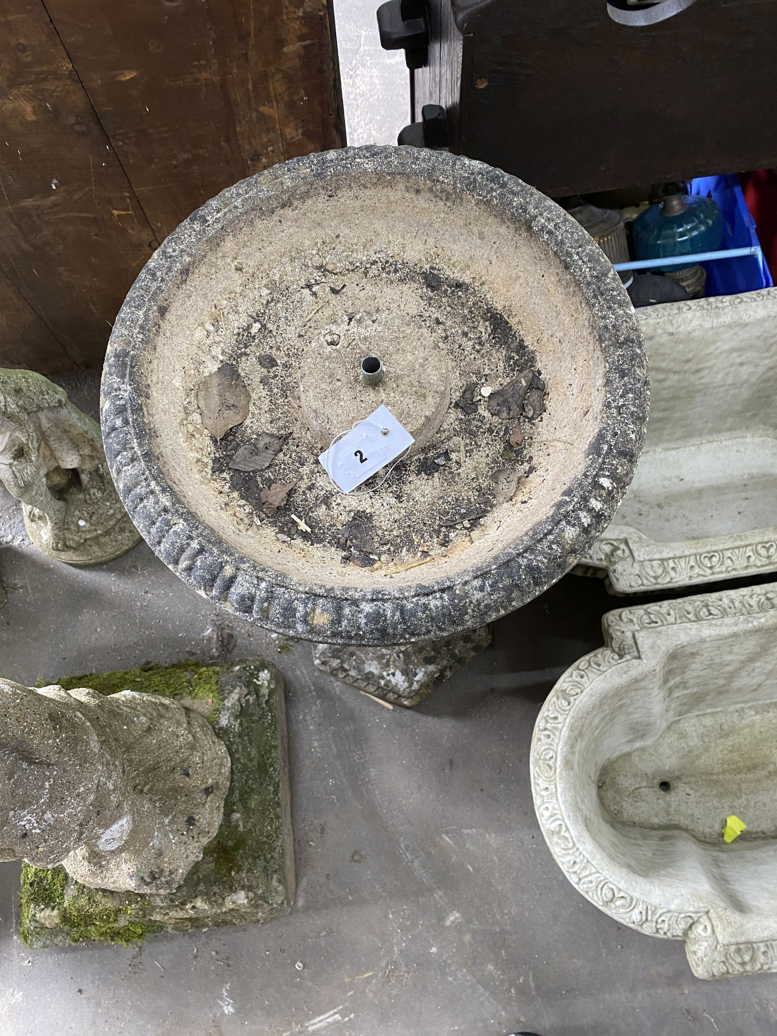 A reconstituted stone octagonal garden fountain / bird bath with dolphin stem, height 82cm